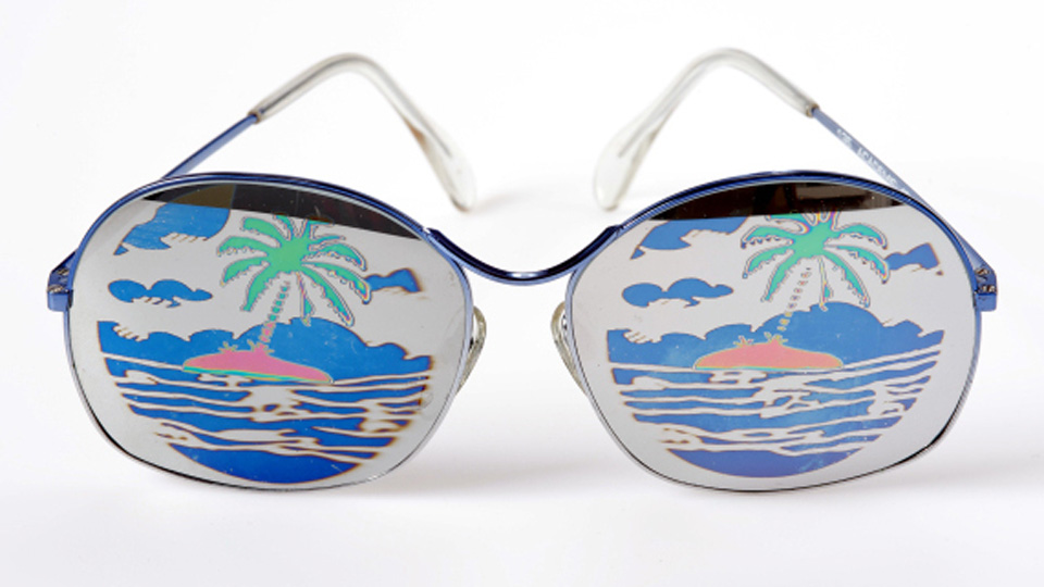 Frames with a desert island and palm trees on the lenses